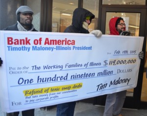 Grassroots Illinois Action delivers a check to a downtown Bank of America branch to demand that Gov Rauner call for negotiating toxic swaps deals - taxpayer money that should fund vital services instead of going to corporate profits; 02/19/15