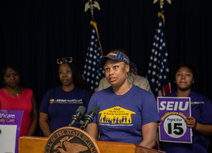Nicole Young, a child care center on the far north side who earns $14 an hour, criticized Mayor Emanuel who undercut the campaign to pass a $15 minimum wage bill.