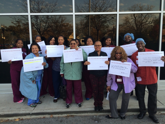 Roseland Hospital workers rally on Nov. 10th, 2015 holding signs that say "I go the extra mile for Roseland" to demonstrate that workers provide quality patient care.
