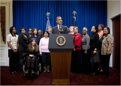 Gilda Brown, far left, stands with President Obama and other home care workers and consumers as he announces new overtime and minimum wage protections for home care workers.